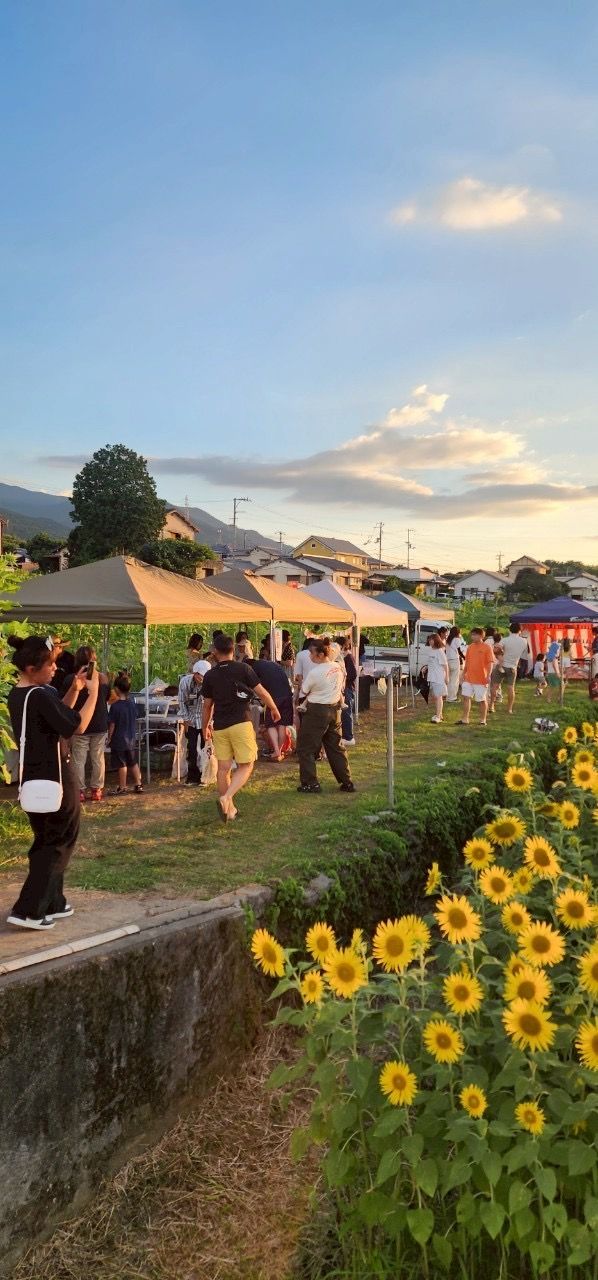 夕暮れの会場に集まる人たち